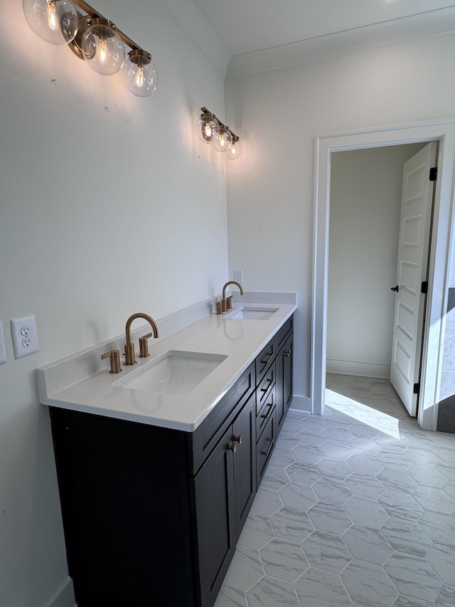 full bathroom with double vanity, crown molding, and a sink