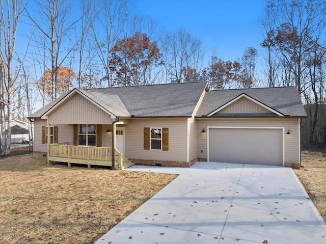 ranch-style house featuring covered porch and a garage