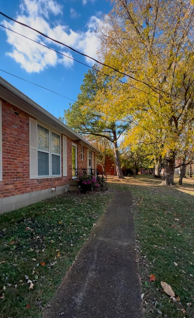 view of side of home featuring a lawn