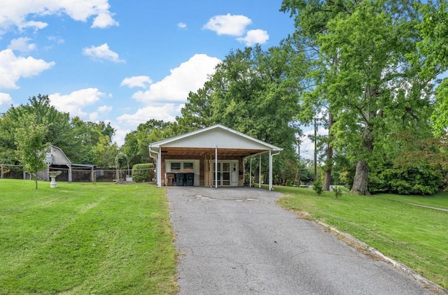 view of front of home with a carport and a front lawn