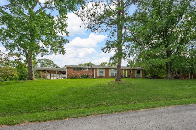 ranch-style house with a carport and a front yard