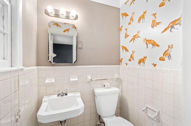 bathroom featuring tile walls, sink, and toilet