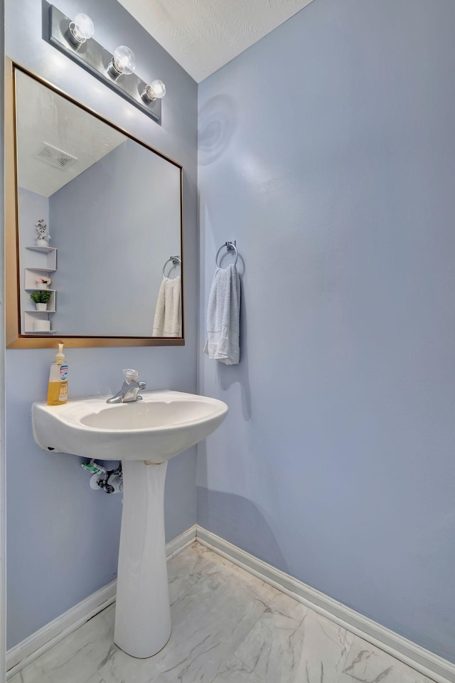 bathroom featuring a textured ceiling