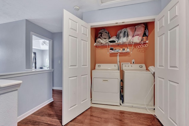 laundry area with hardwood / wood-style flooring and washer and clothes dryer