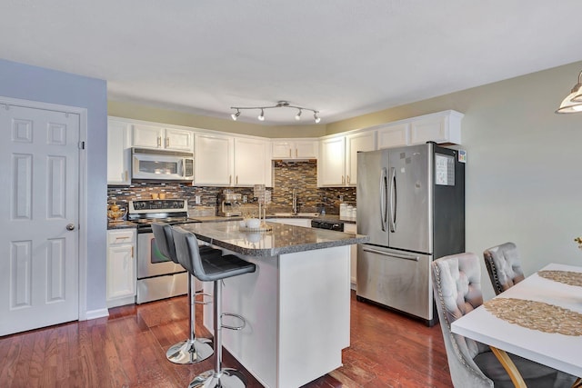 kitchen featuring white cabinetry, dark wood-type flooring, and stainless steel appliances