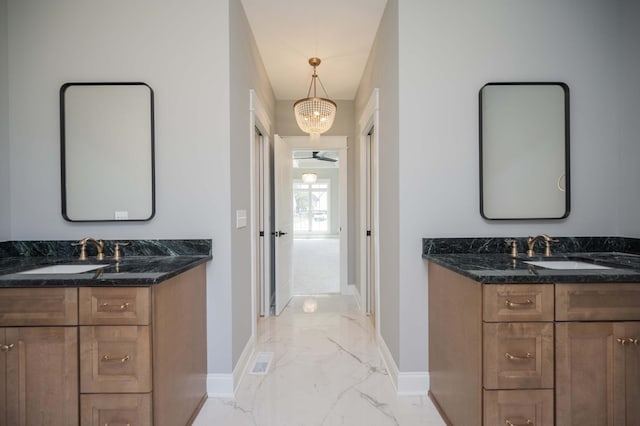 bathroom with vanity and an inviting chandelier