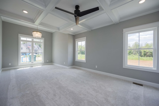 empty room featuring carpet flooring, ceiling fan with notable chandelier, and plenty of natural light