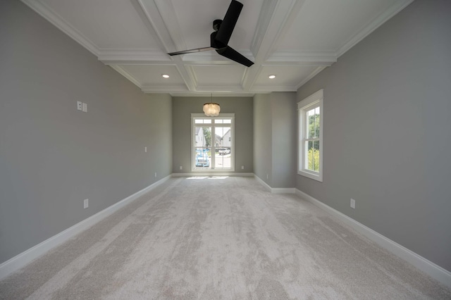 carpeted spare room featuring beam ceiling, crown molding, ceiling fan, and coffered ceiling