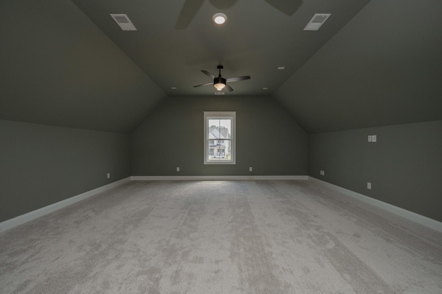 additional living space featuring light colored carpet, vaulted ceiling, and ceiling fan