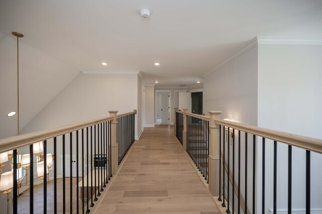 hall featuring light hardwood / wood-style flooring and ornamental molding