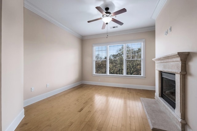 unfurnished living room with ceiling fan, crown molding, and light hardwood / wood-style flooring