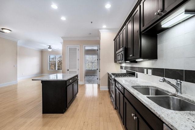 kitchen featuring light stone countertops, sink, ceiling fan, and appliances with stainless steel finishes