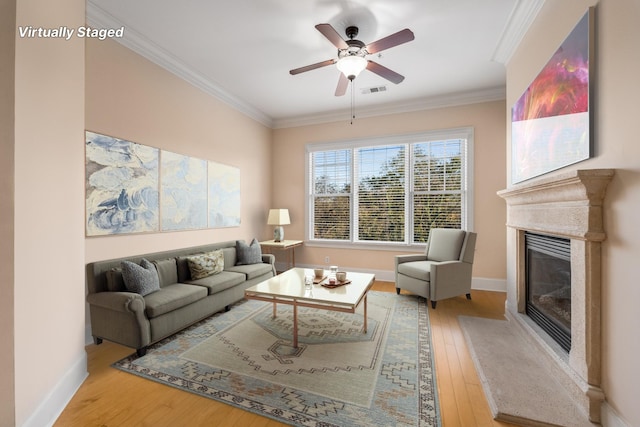 living room with crown molding, ceiling fan, and hardwood / wood-style flooring