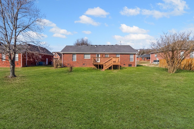 back of house featuring a wooden deck and a yard