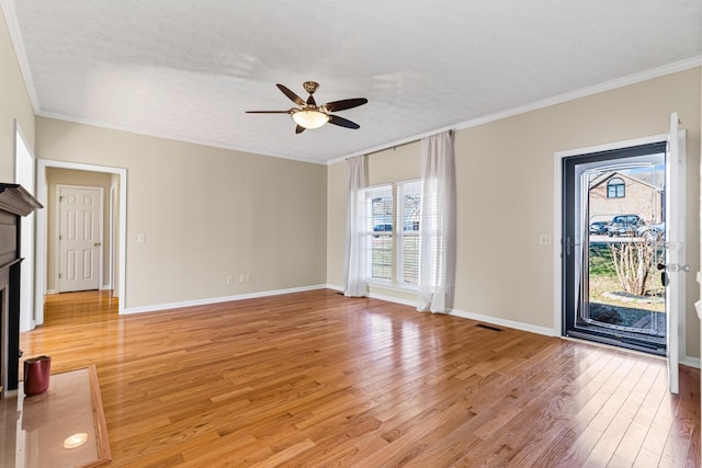 unfurnished living room featuring ceiling fan, wood-type flooring, and crown molding