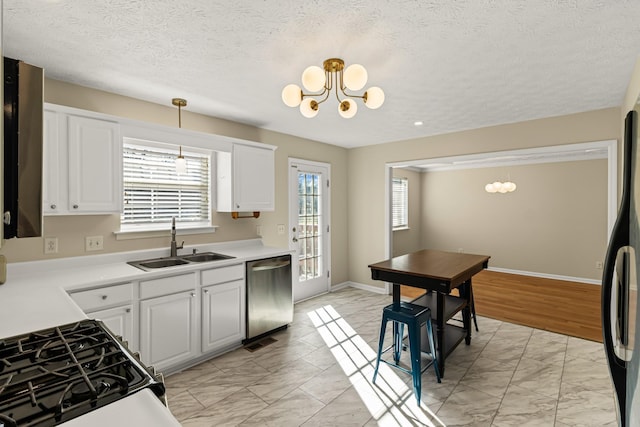 kitchen featuring decorative light fixtures, a notable chandelier, dishwasher, sink, and white cabinetry