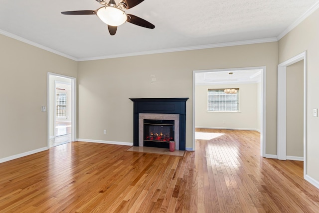 unfurnished living room with light hardwood / wood-style floors, a textured ceiling, crown molding, and ceiling fan