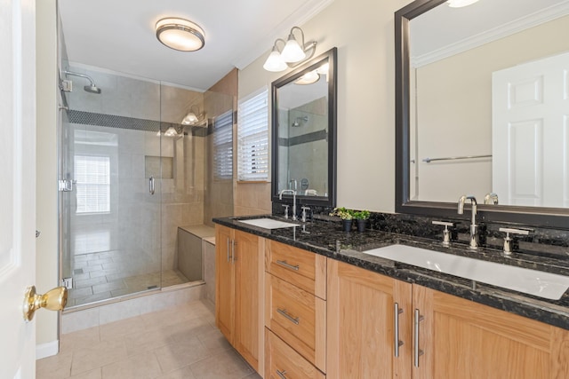 bathroom with tile patterned floors, a shower with door, crown molding, and vanity