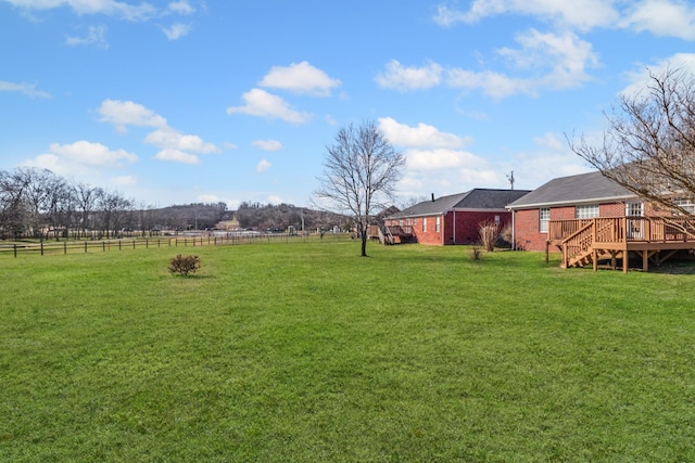 view of yard with a deck and a rural view