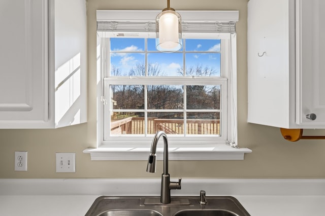 details featuring white cabinets and sink