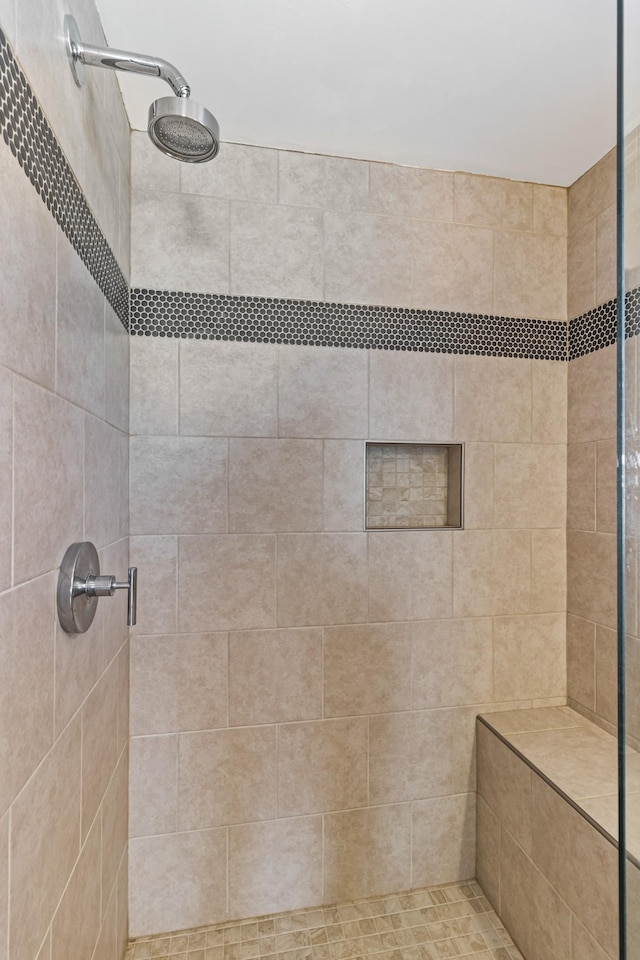 bathroom with tiled shower