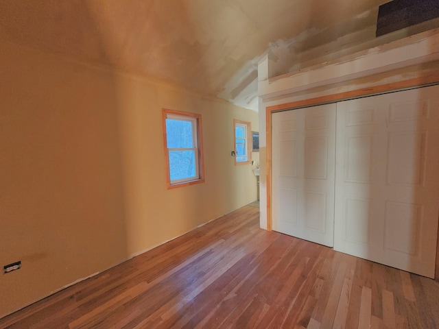 unfurnished bedroom featuring a closet and light wood-type flooring