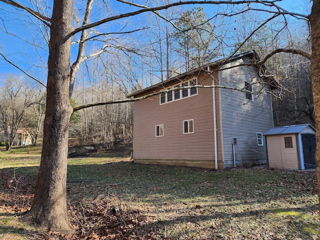 view of property exterior with a storage unit