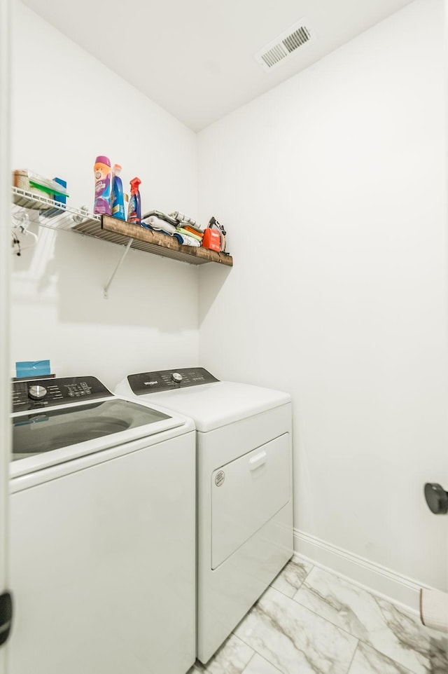 washroom featuring washer and clothes dryer