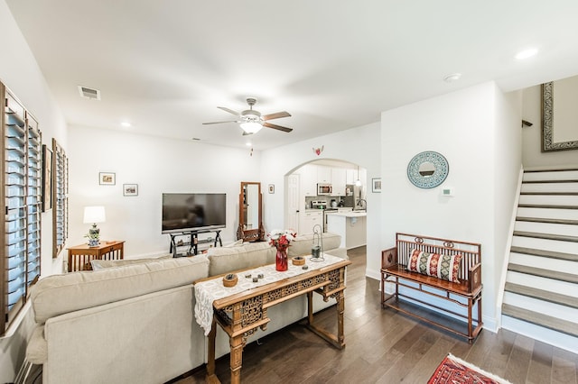 living room featuring dark hardwood / wood-style floors and ceiling fan