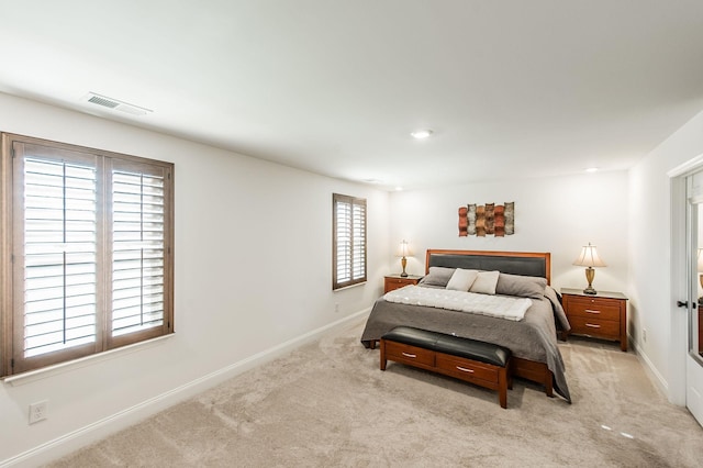 bedroom featuring light carpet