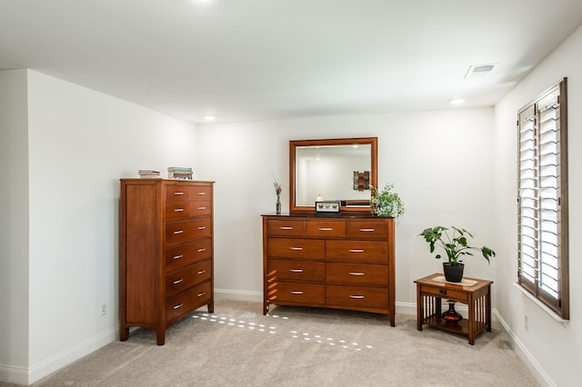 interior space with light carpet and multiple windows