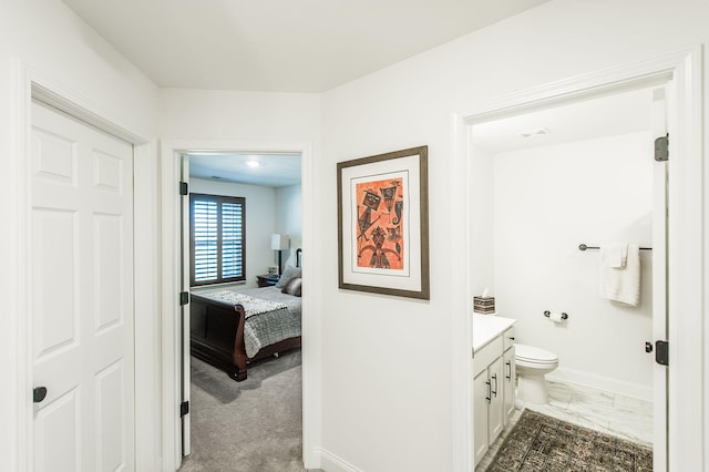 interior space with vanity and toilet