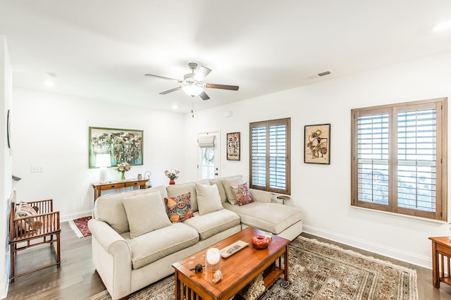 living room featuring hardwood / wood-style floors and ceiling fan