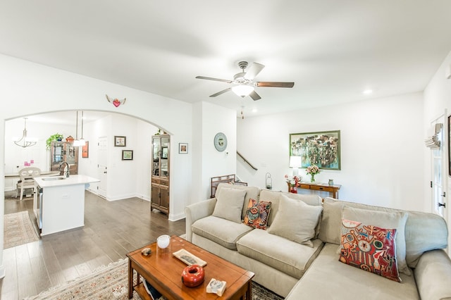 living room featuring ceiling fan, dark wood-type flooring, and sink