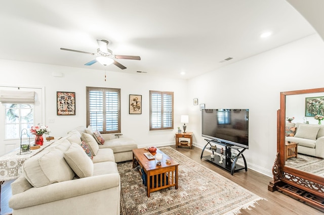 living room with ceiling fan and wood-type flooring