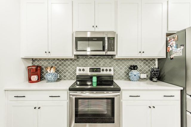 kitchen with white cabinetry, appliances with stainless steel finishes, and tasteful backsplash