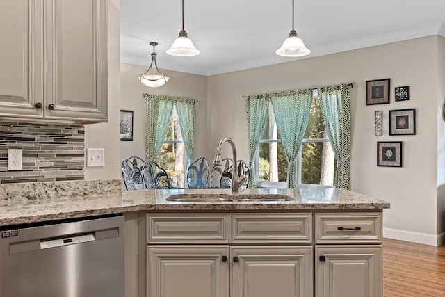 kitchen featuring dishwasher, light stone countertops, a wealth of natural light, and sink