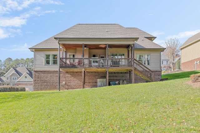 back of property featuring a wooden deck, ceiling fan, and a yard