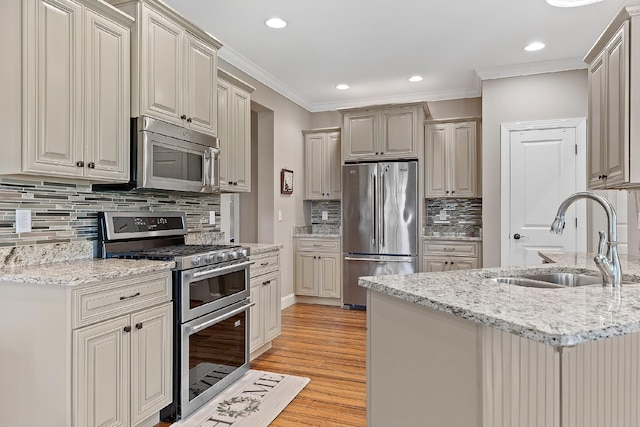 kitchen featuring light wood-type flooring, tasteful backsplash, ornamental molding, stainless steel appliances, and sink