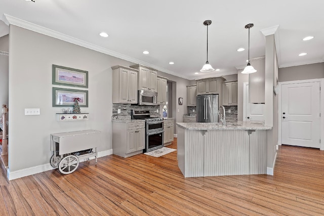 kitchen with gray cabinets, decorative backsplash, light hardwood / wood-style flooring, and appliances with stainless steel finishes