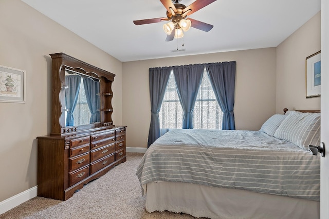 bedroom with light carpet and ceiling fan