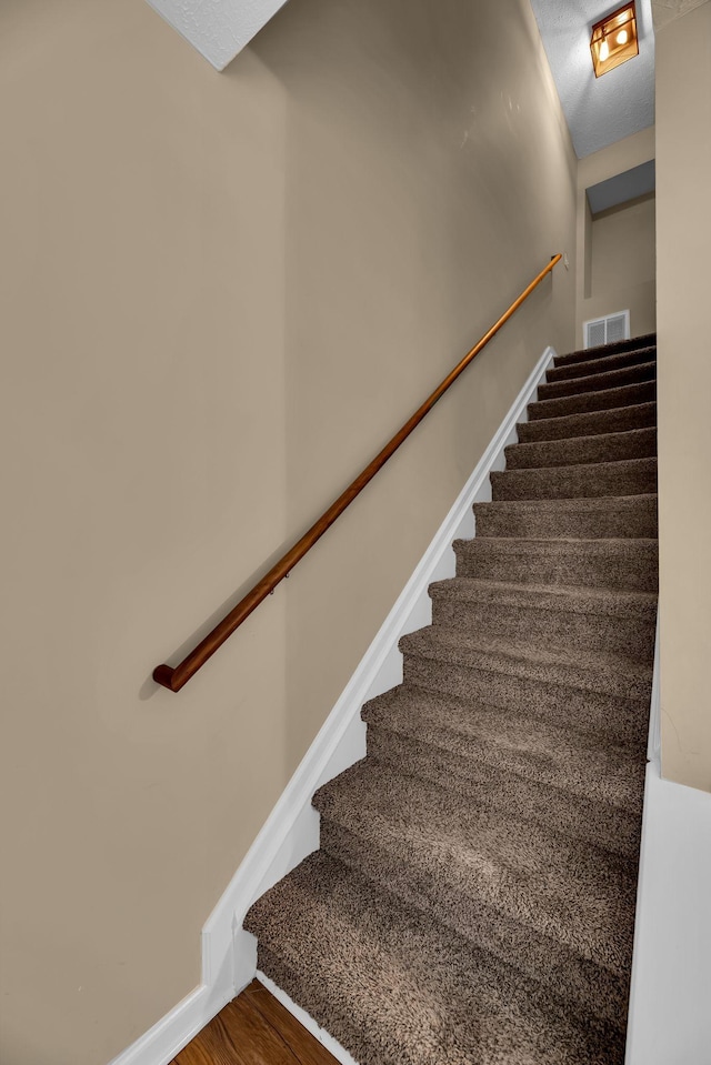 stairs with wood-type flooring