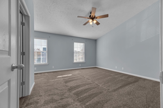 spare room featuring carpet flooring, ceiling fan, and a textured ceiling