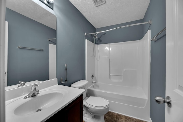 full bathroom featuring vanity, a textured ceiling, bathing tub / shower combination, and toilet