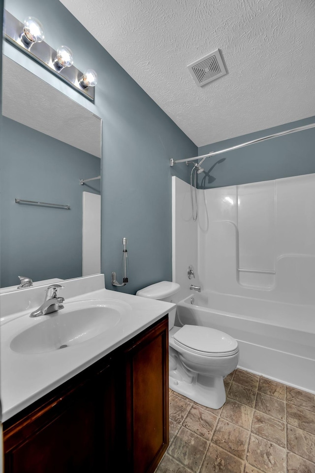 full bathroom featuring vanity, toilet, shower / tub combination, and a textured ceiling