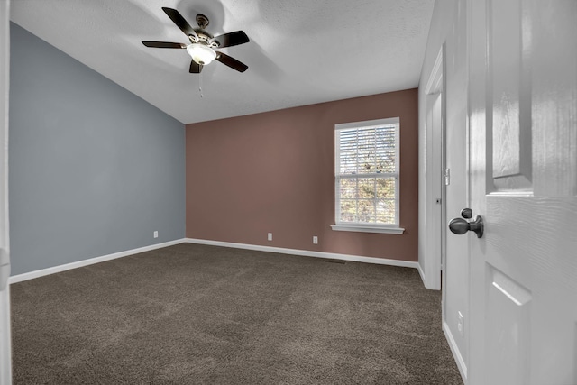 unfurnished room with ceiling fan, dark carpet, and a textured ceiling