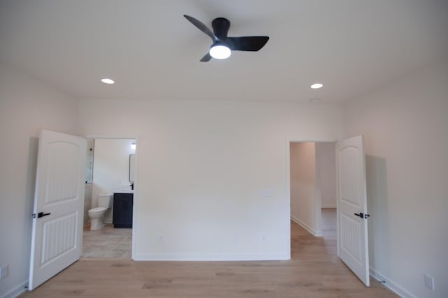 spare room with light wood-type flooring and ceiling fan