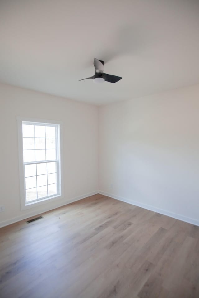 empty room featuring ceiling fan and light hardwood / wood-style flooring