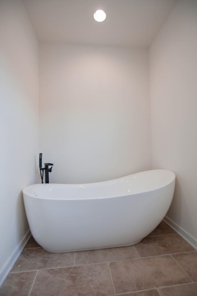 bathroom featuring tile patterned flooring and a bathtub