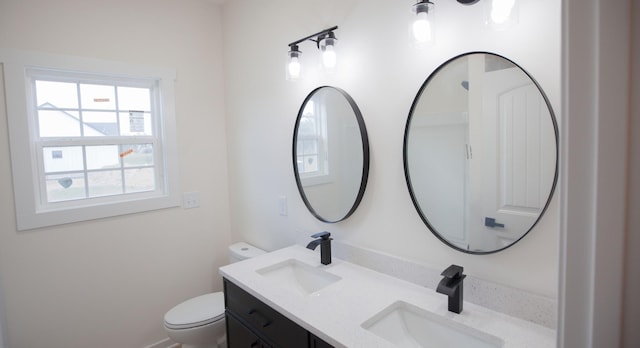 bathroom featuring toilet and vanity